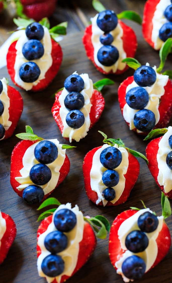 red, white and blue strawberries are arranged on a tray