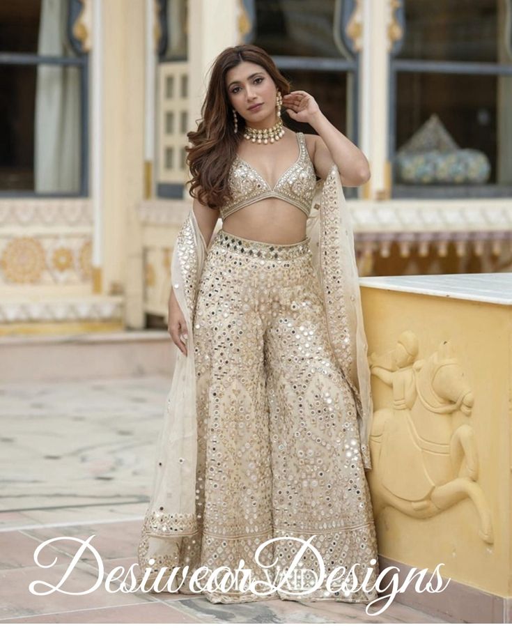 Made to Order/Measurement/Custom Order Lehenga - Color : beige gold - Fabric : georgette - Fully flared paneled sharara - - It can be customize in any design or size and color PLEASE NOTE: BUYERS ARE RESPONSIBLE FOR ANY CUSTOMS AND IMPORT TAXES THAT MAY APPLY. This is a made to order product. If you opt for 'Made To Measurement Option', we will provide a measurement template and you can share the measurements likewise. If you want to opt for 'Standard Size', Please refer to the size chart provided in the listing. Shipping: Standard Shipping is done by DHL ecommerce and it mostly takes 2 to 3 weeks to deliver after dispatch. Express Shipping is done by DHL express and it mostly delivers within a week after dispatch. Fabric Care : Dry Clean Only PLEASE NOT THE FRINGES IN THE BLOUSE ARE HANDM Mirror Work Sharara, Full Mirror, Lehenga Blouse, Indian Lehenga, Embroidered Dupatta, Dupatta Set, Sharara Set, Chaniya Choli, Indian Wedding Outfits