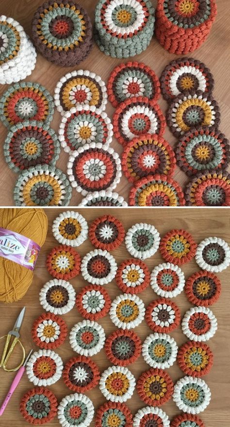 crocheted grannys are arranged on the floor with yarn