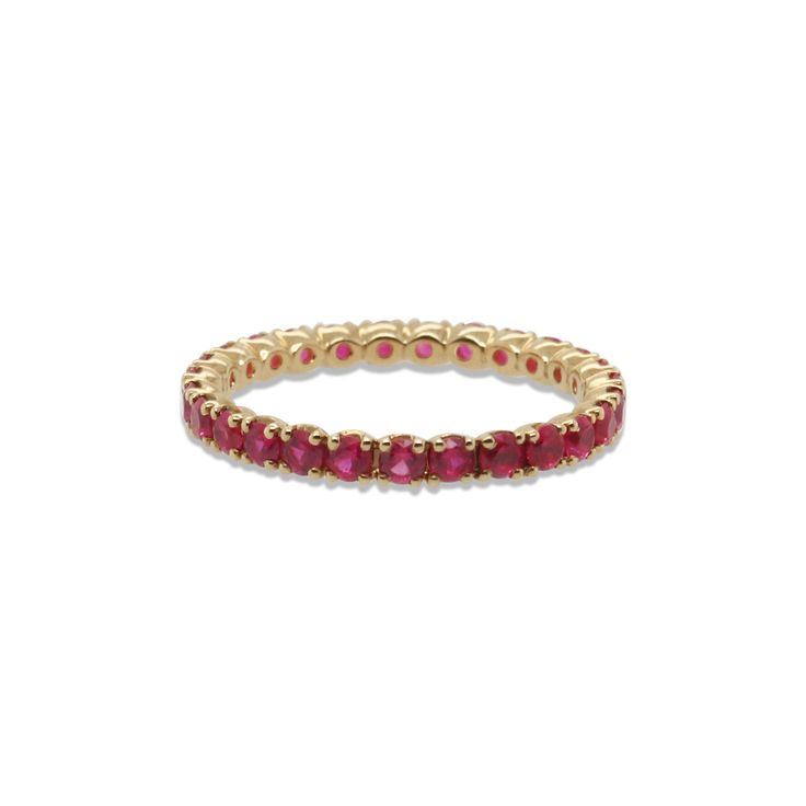 a yellow gold ring with red stones