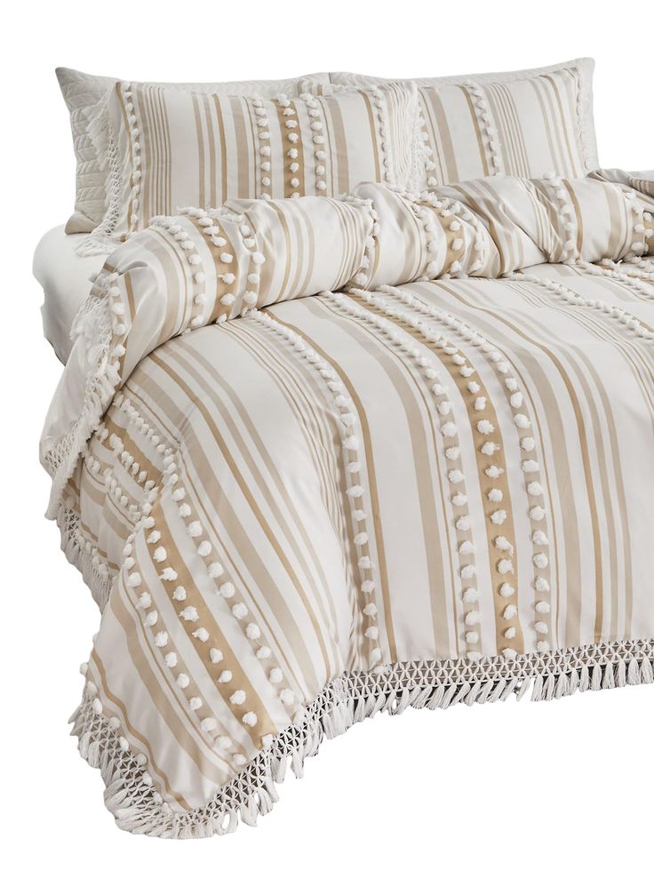 a bed with white and tan striped sheets on it's side, along with two pillow cases