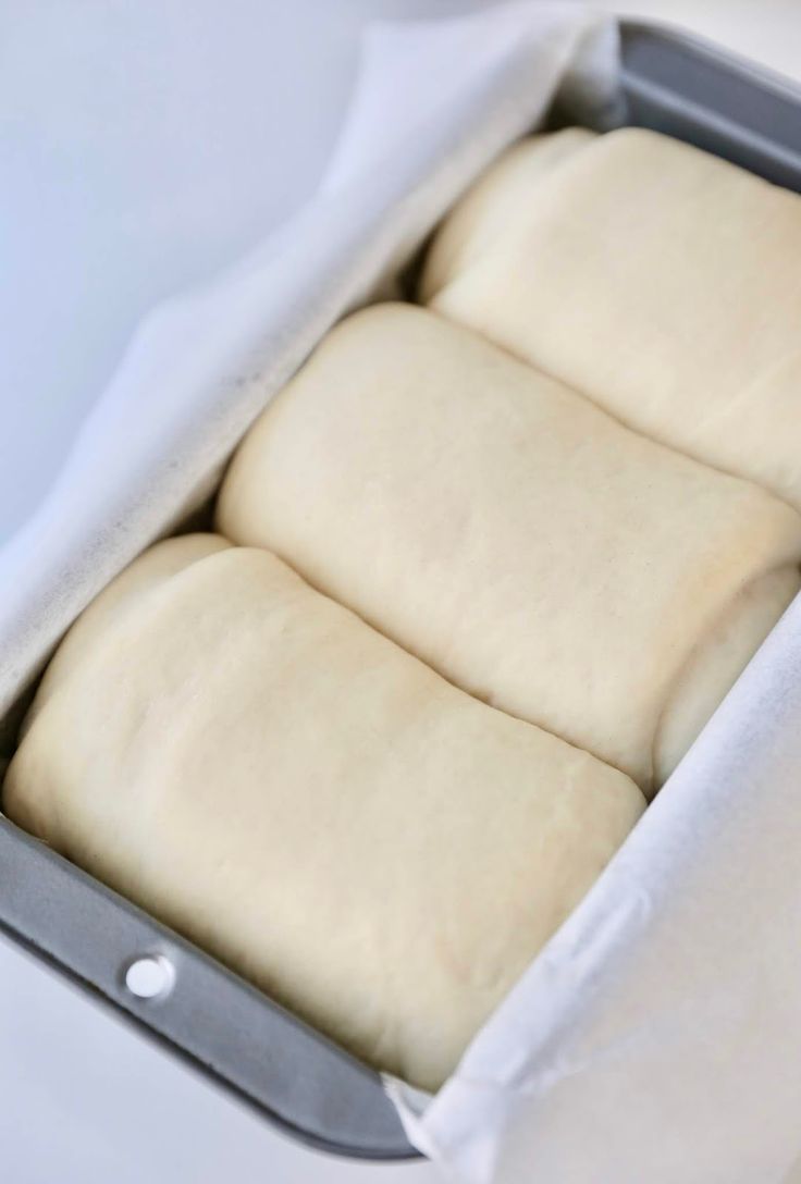 four loaves of bread in a baking pan