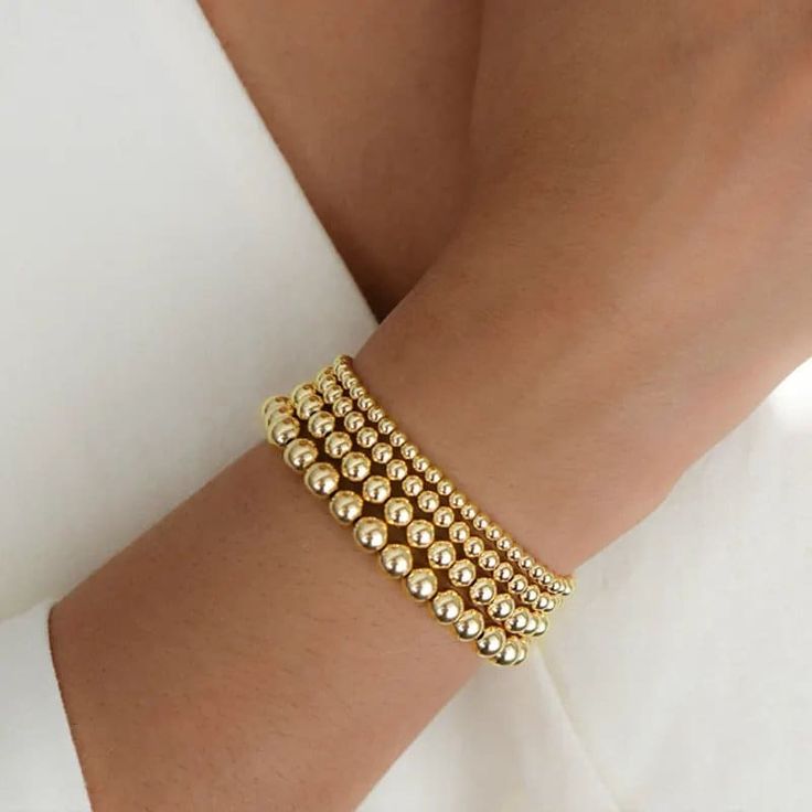 Our handcrafted 14K Gold Filled Bracelets are classic & timeless - as well as waterproof + tarnish resistant. Great for layering, stacking or alone! They look fabulous with any outfit or style. I am happy to accommodate custom design + sizes requests, as well as bundle deals. :) Just message me! Many customer love to pair them with our 14K Gold Filled Personalized Name/Word Bracelets: https://www.etsy.com/listing/1063339472/14k-gold-filled-personalized-bracelet? Bracelets come in our high-qualit Gold Bracelet Set, Everyday Bracelet, Coin Bracelet, Gold Bead Bracelets, Ball Bracelet, Stackable Bracelets, Elastic Bracelet, Layered Bracelets, Strand Bracelet