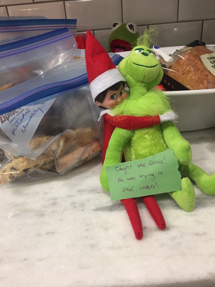 an elf is sitting on the counter next to some food