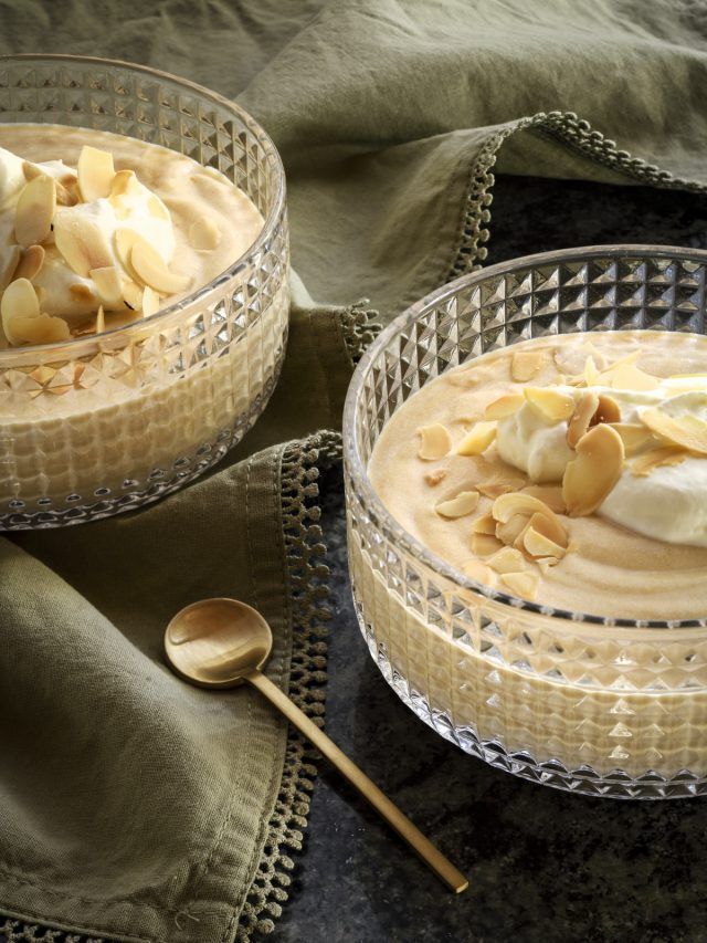 two glass bowls filled with food on top of a table