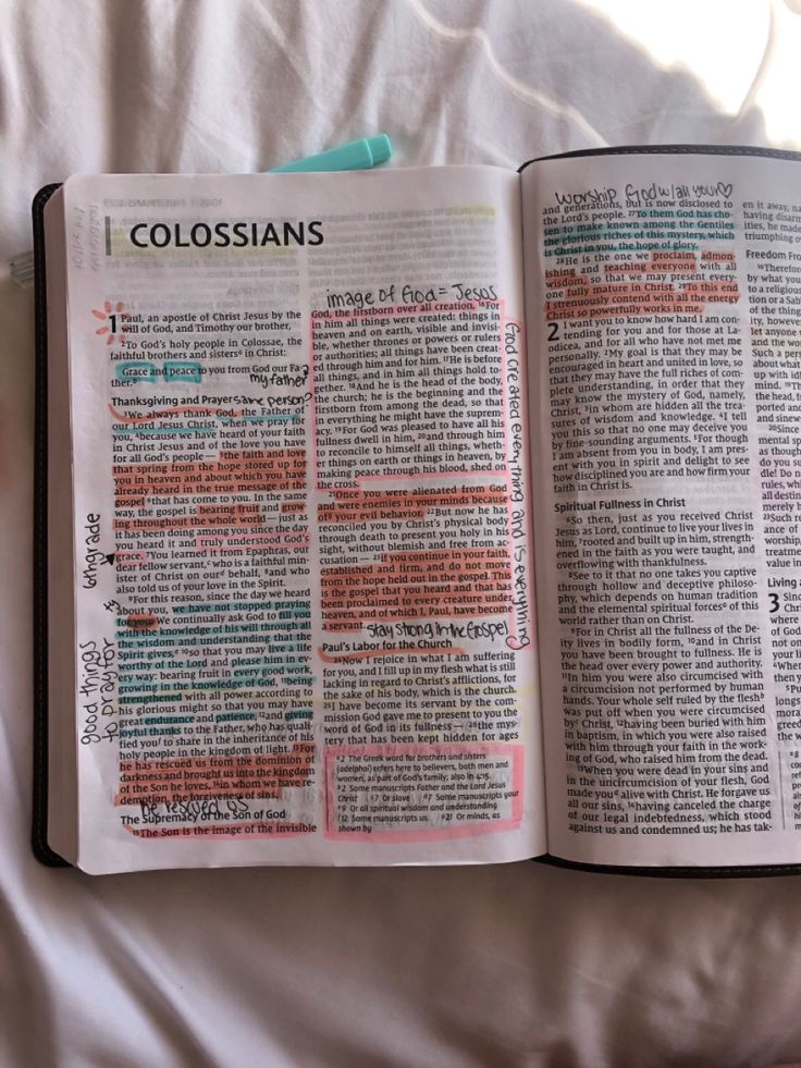 an open bible laying on top of a bed