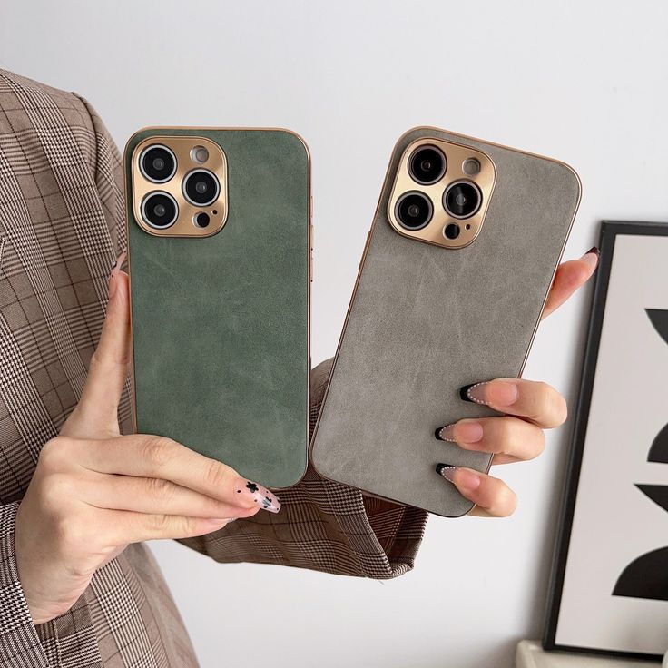 a woman holding two iphone cases in her hands