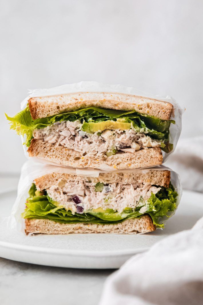 two sandwiches stacked on top of each other with lettuce and meat in them