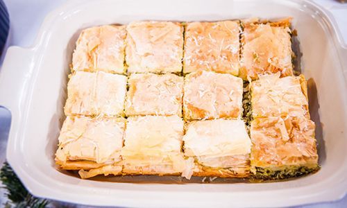 there is a casserole dish that has been cut into squares and placed on a table