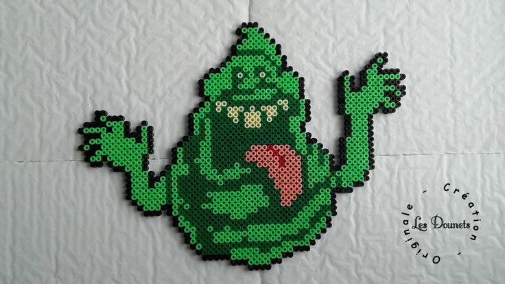 an image of a pixelated green creature with its tongue hanging from it's mouth