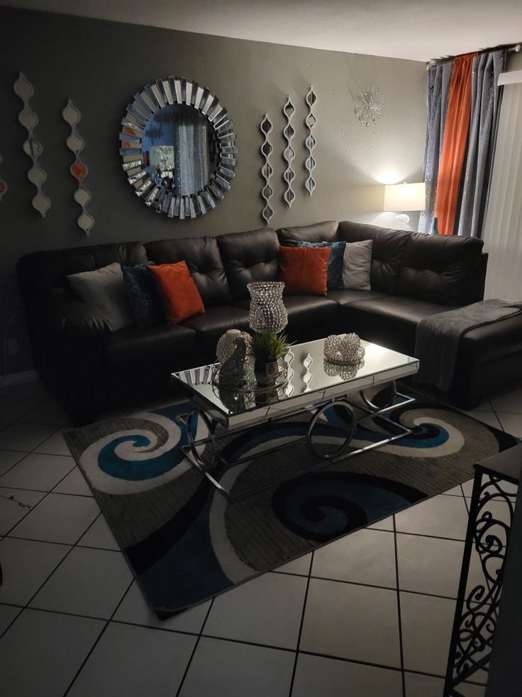 a living room filled with furniture and a large mirror on the wall above it's coffee table