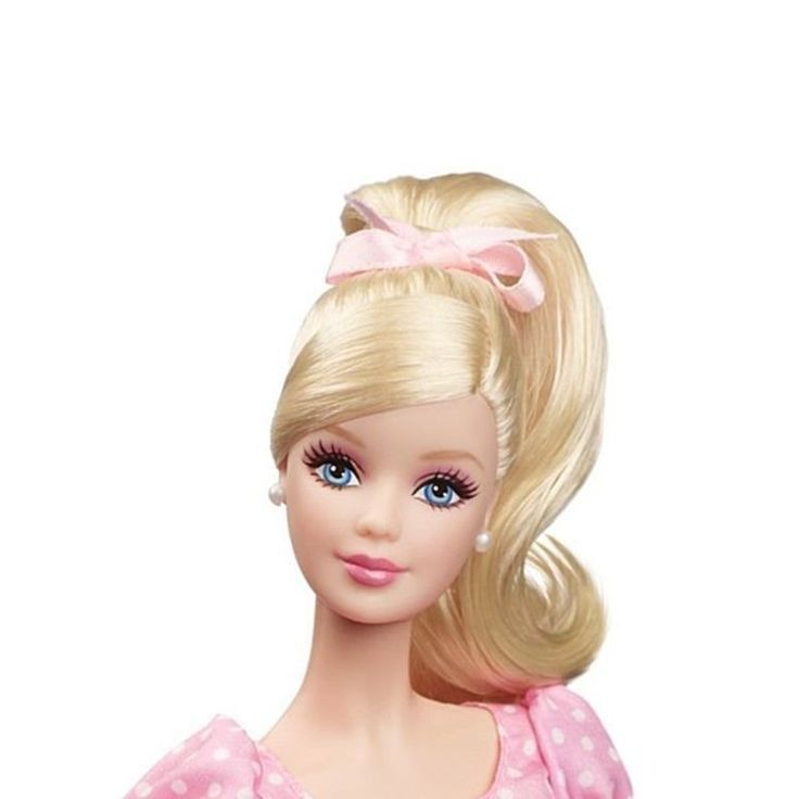 a barbie doll with blonde hair wearing a pink polka dot dress and pearl earrings on her head