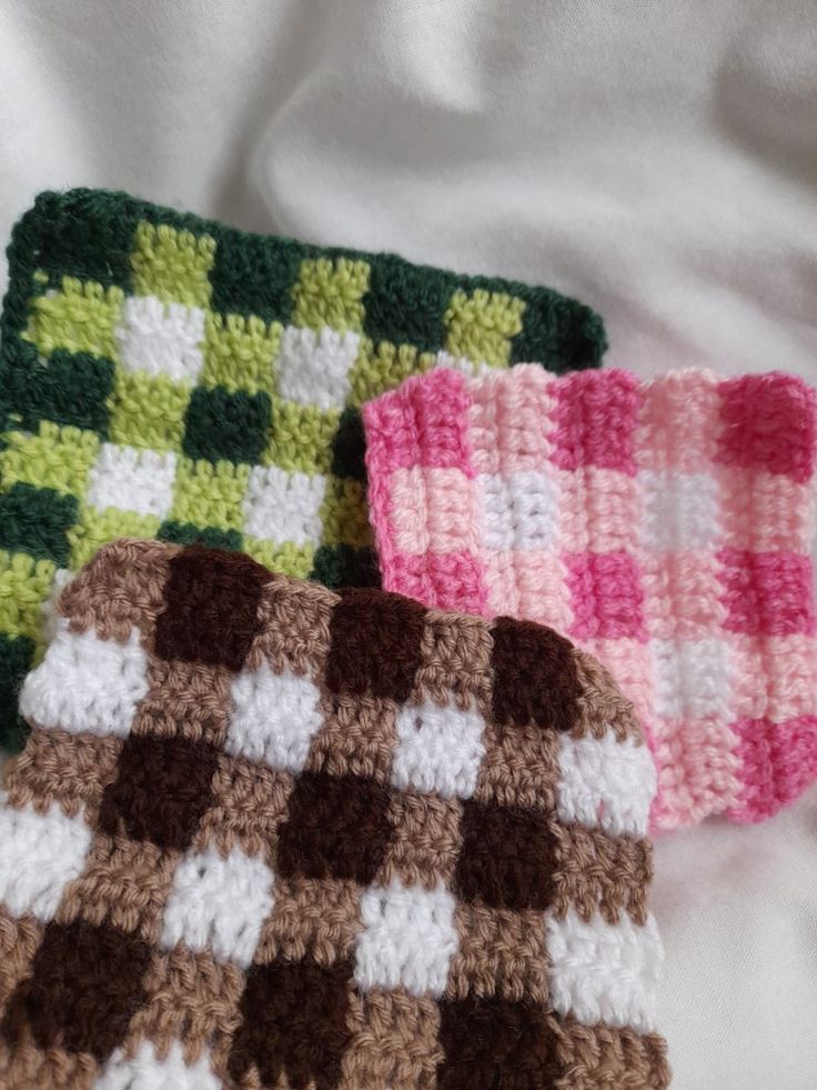 three crocheted dishcloths laying on top of each other