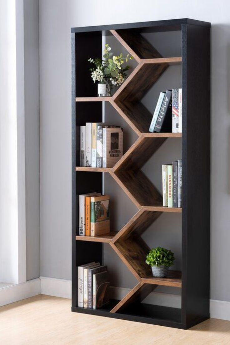 a book shelf with books on it and some plants in the corner next to it