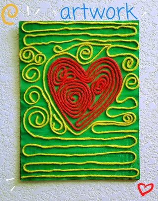 a green square with a red heart on it and the words art work written below