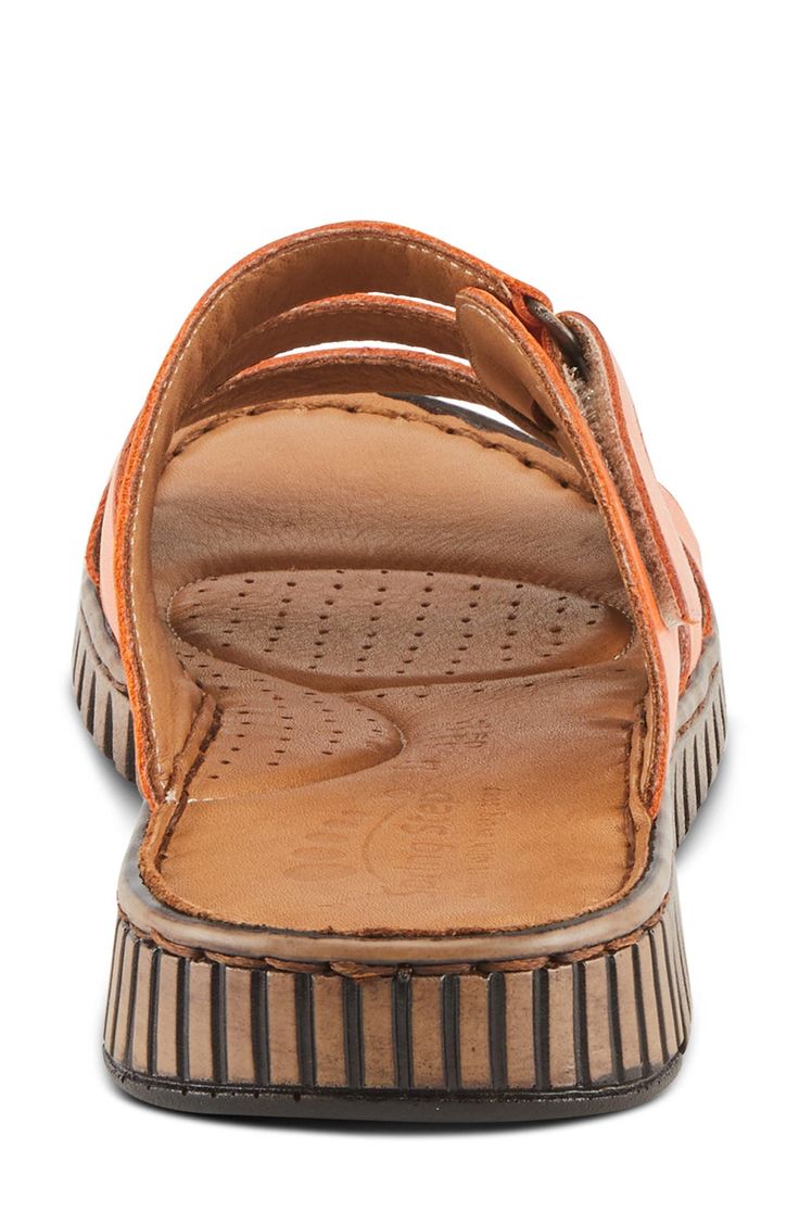 An adjustable instep strap offers a customized fit on a leather slide sandal grounded by a cushioned footbed for lasting comfort. 1" heel Adjustable strap with hook-and-loop closure Cushioned footbed Leather upper and lining/synthetic sole Made in Turkey Leather Slide Sandals With Arch Support, Comfortable Slides With Adjustable Strap And Round Toe, Adjustable Leather Slippers With Arch Support, Leather Cushioned Slide Sport Sandals, Leather Slide Sport Sandals With Cushioned Footbed, Leather Sport Sandals With Arch Support, Leather Slide Slippers With Arch Support, Adjustable Slides With Leather Footbed, Leather Slippers With Arch Support, Slide Shape