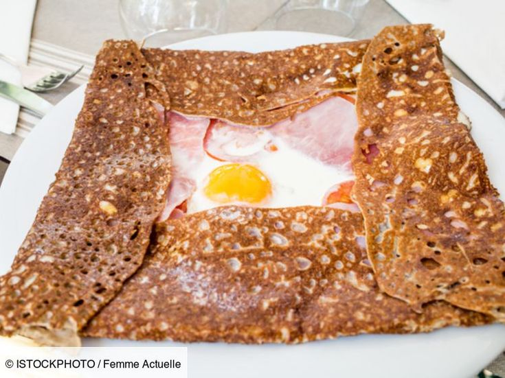 a plate topped with pancakes and an egg