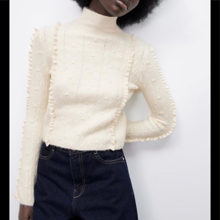 Size: S Color: Light Ecru Ref. 4331/136 High Collar Long Sleeve Sweater. Pompons And Lace Ruffle Detail. Main Fabric: 55% Acrylic. 4% Elastane. 28% Polyester. 13% Polyamide Lace: 100% Cotton Chic Cream Sweater, Feminine Textured Knit Winter Sweater, Chic Long Sleeve Sweater With Ruffles, Chic Cream Pointelle Knit Sweater, Casual Cream Sweater With Ruffles, Cream Ruffled Sweater For Spring, Chic Cream Fine Knit Sweater, Chic Winter White Pointelle Knit Sweater, White Ruffled Sweater For Spring