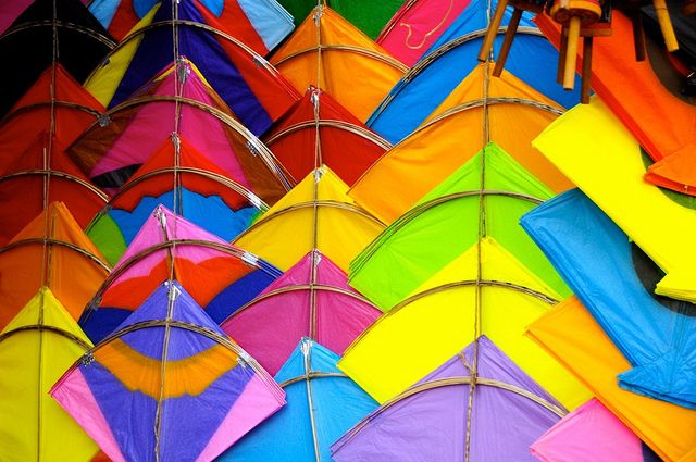 many different colored kites are on display together