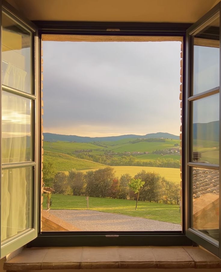 an open window looking out onto the countryside