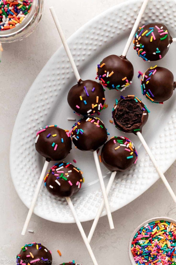 chocolate covered donuts with sprinkles on a white plate