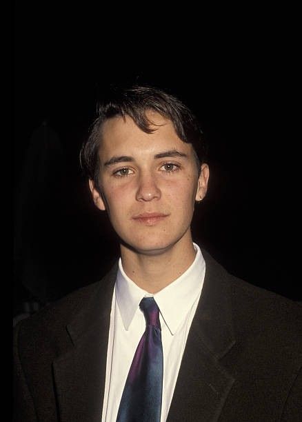 a young man wearing a suit and tie