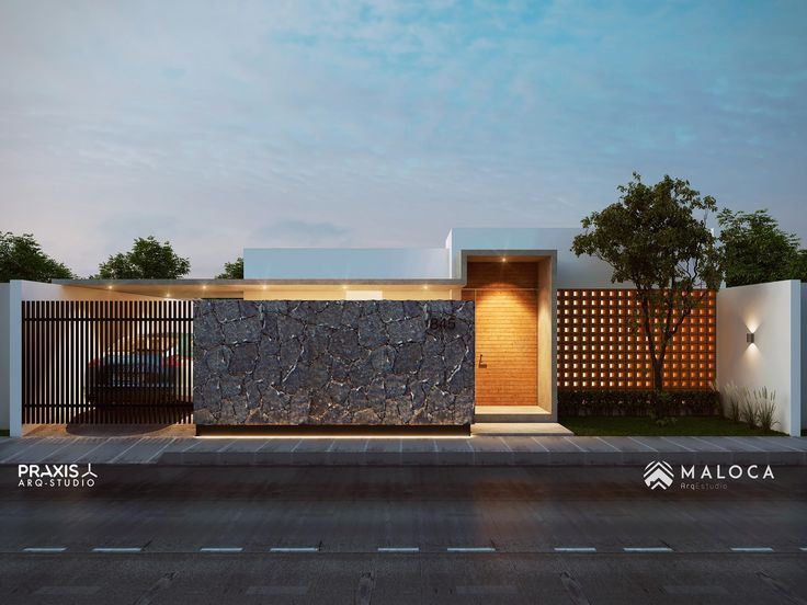 a modern house with a stone wall in the front yard