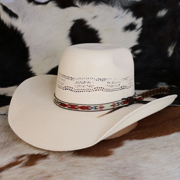 The Resistol Young Gun Jr. Youth Cowboy Hat combines style and durability with its rough-and-tough Bangora construction, featuring a 4 3/4" rounded brick crown and a 4” brim. The hat's unique design includes a feather and a Native American-inspired pattern on the hatband, making it a standout accessory for young cowboys and cowgirls. With an elastic sweatband to accommodate size changes, this hat is a versatile and practical choice for children as they grow and explore the great outdoors. Brim - 4" Crown - 4 1/4" Bangora Straw Toddler Cowboy Hat, Cowgirl Hats Western, Botas Western, Flat Top Hat, Womens Straw Hats, Country Hats, Woven Hat, Southern Outfits, Straw Cowboy Hat