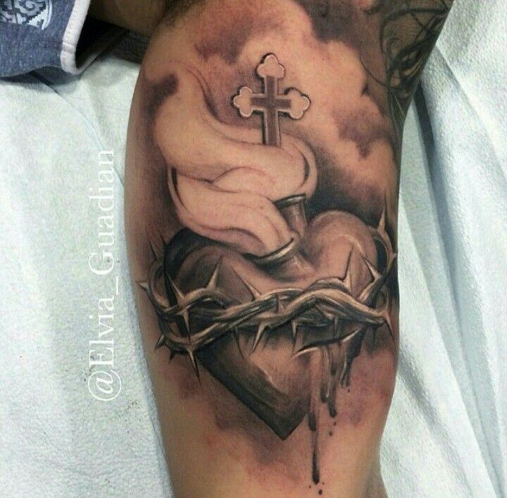 a tattoo on the arm of a person with a cross