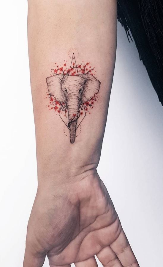 an elephant's head is shown on the wrist and it has blood splatters all over it