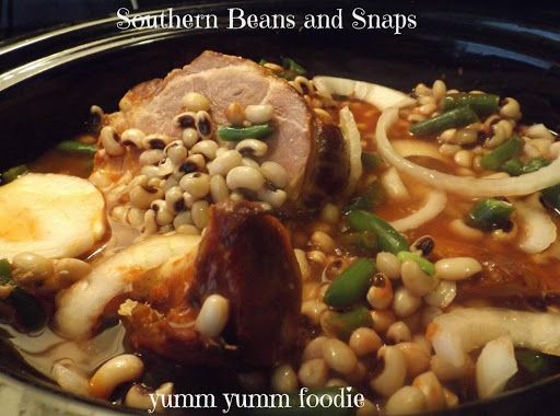 a bowl filled with beans and meat on top of a table