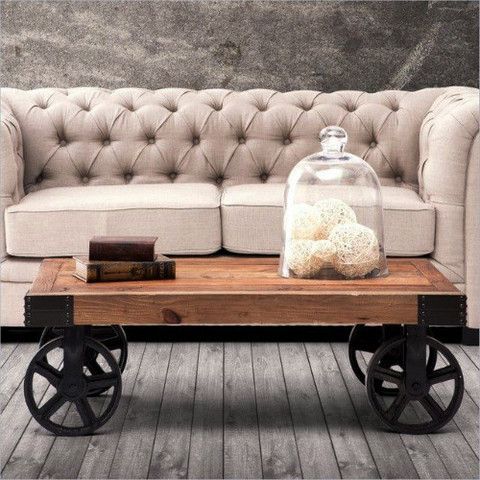 a coffee table with wheels on it and a couch in the background, both side by side