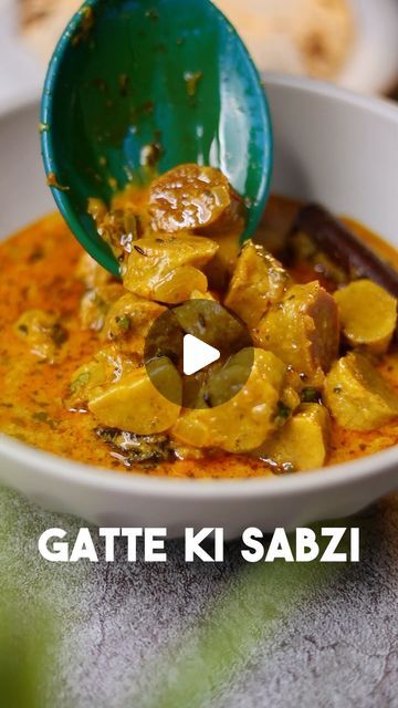 a bowl full of food with a spoon in it and the words gate k sabzi