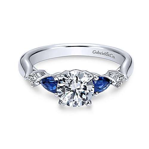 a white gold engagement ring with blue sapphire stones on the side and diamond accents around the band