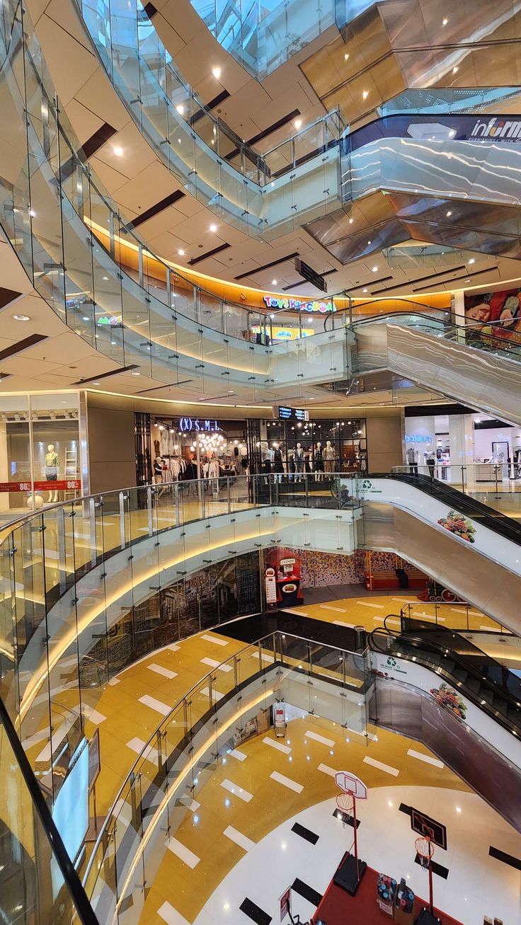 the inside of a shopping mall with multiple floors and glass balconies on each floor