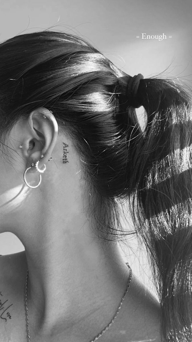 black and white photograph of woman with ear piercings