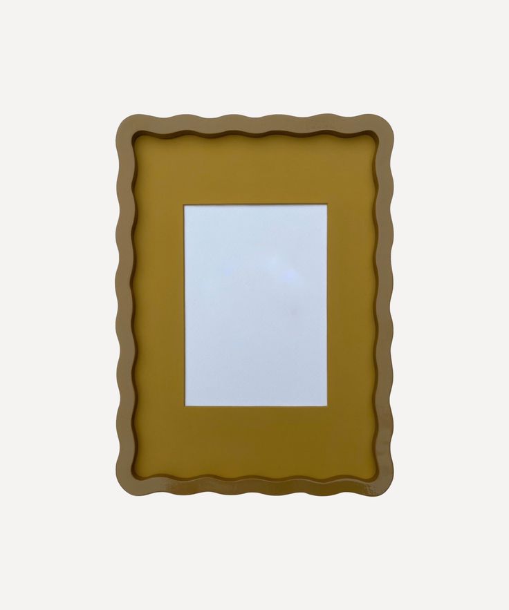 a small square shaped object with a white surface in the middle and brown frame around it