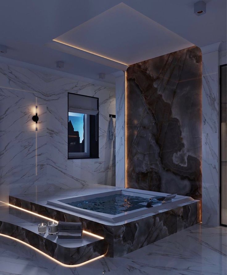 a bathroom with a large jacuzzi tub next to a window and lights on the wall