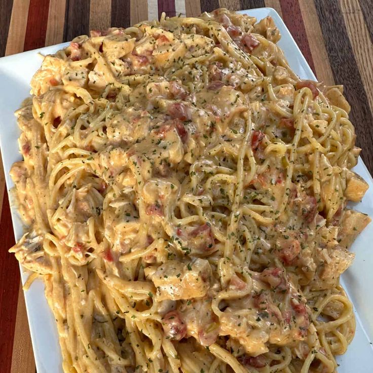 a white plate topped with pasta covered in sauce