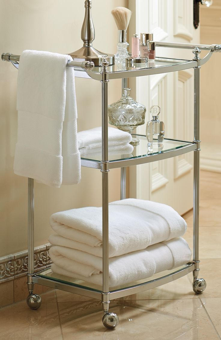 a bathroom shelf with towels and other items on it