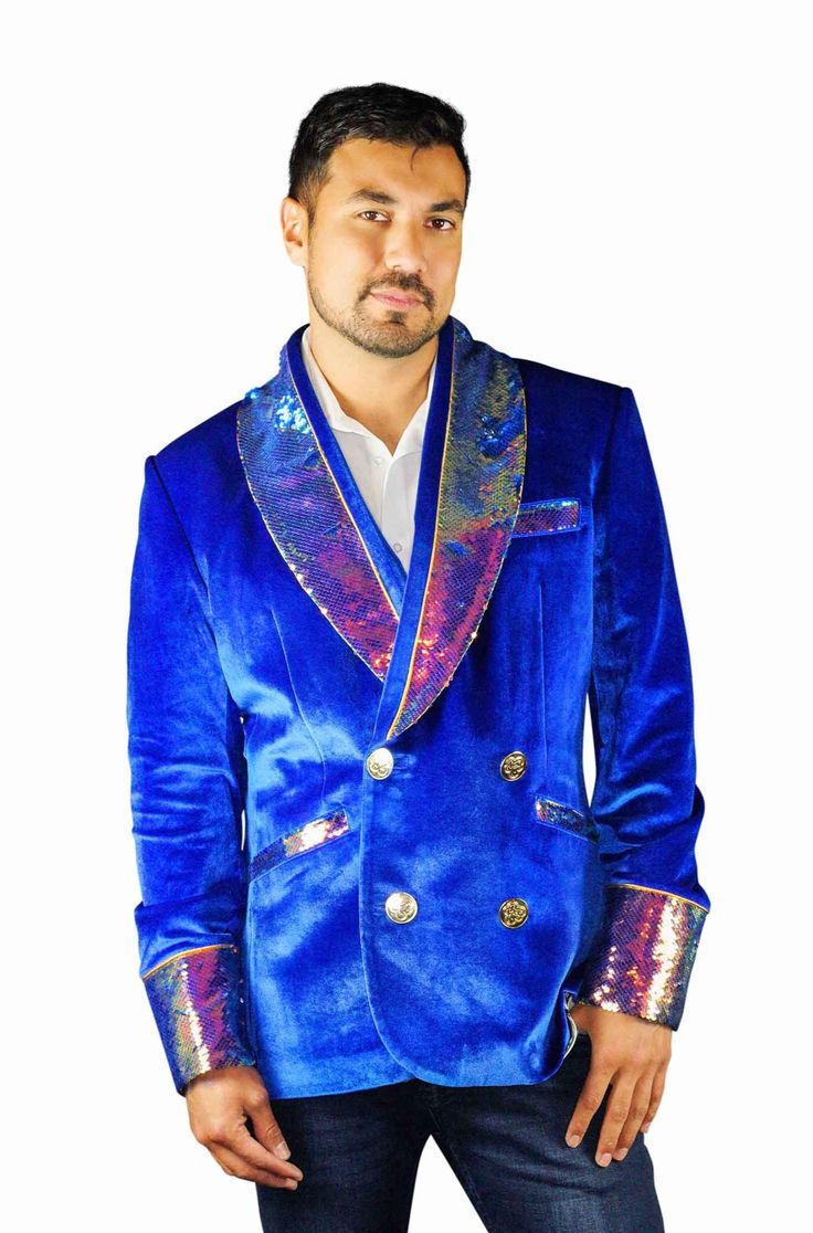 This mens royal blue velvet smoking jacket exudes a certain sophistication that other jackets can only dream of. We have taken this perfectly tailored,double breasted blazer to the next level with the addition of iridescent multi color flip sequins. FEATURES: Double breasted Fully lined with our signature satin 4 pockets including 1 inside breast pocket Reversible iridescent sequin contrast collar, cuffs and trim Velvet trimmed collar to for ultimate comfort Ethically made in-house in our studio Winter Party Blue Blazer, Luxury Velvet Outerwear For Party, Blue Velvet Winter Outerwear, Double-breasted Suits For Fall Party, Tuxedo Style Blazer With Sequins, Sequined Tuxedo Blazer With Long Sleeves, Royal Blue Winter Outerwear, Fitted Royal Blue Winter Blazer, Royal Blue Long Sleeve Party Blazer