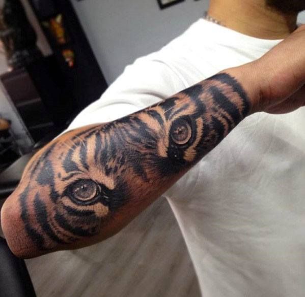 a man with a tiger tattoo on his arm and shoulder, in front of an instagram page