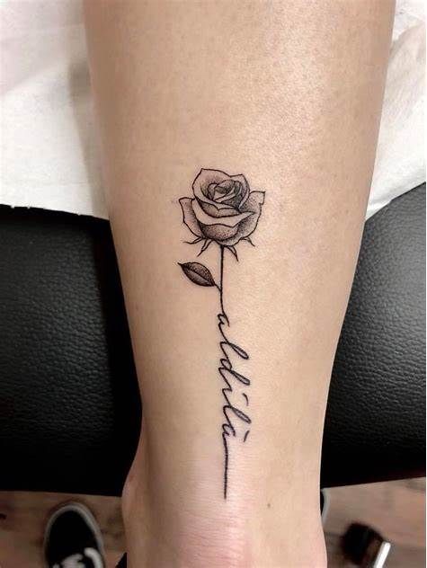 a rose with the word faith written on it and a single flower in the middle