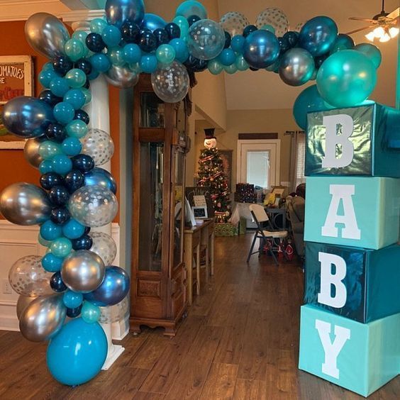 an arch made out of blocks and balloons with the words baby on it in blue