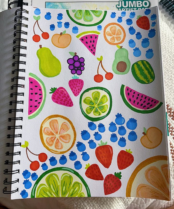 an open spiral notebook with fruit and berries on it