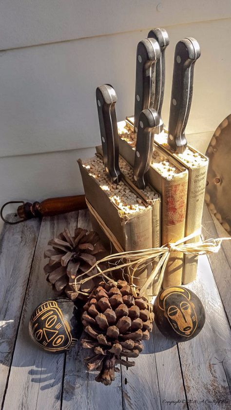 an assortment of knives and pine cones on a wooden table