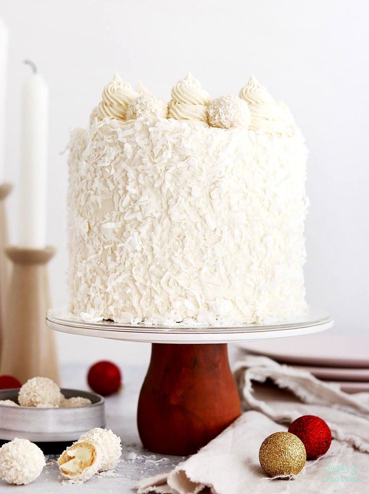 a white frosted cake sitting on top of a table