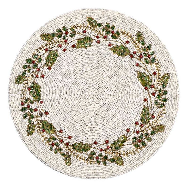 a white round rug with holly leaves and berries on the center, surrounded by red berries