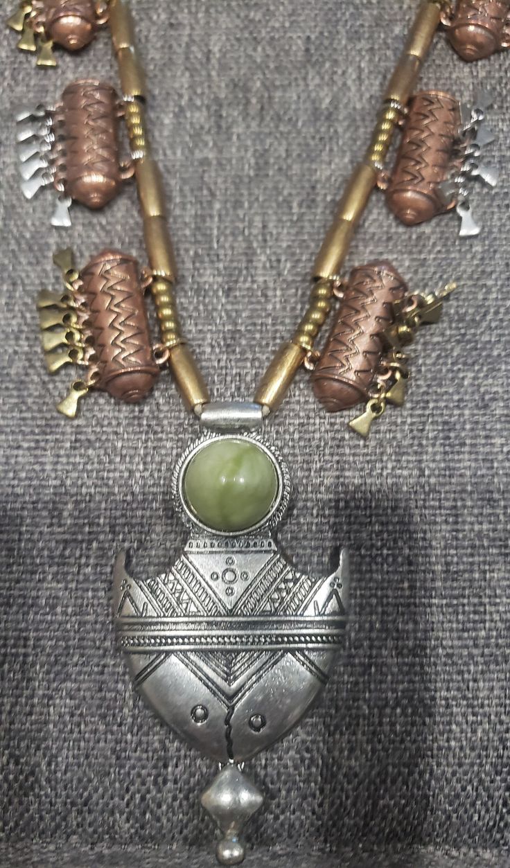 Vintage Tribal Ethnic design green stone brass and silver metal necklace One of the brass beads is half loose so it needs to be fixed. Sell as is Please message me about any questions Green Metal Jewelry With Silver Beads, Silver Necklaces With Natural Stones In Brass, Green Metal Necklaces For Festivals, Green Metal Necklace For Festival, Traditional Green Necklace With Dangling Beads, Green Pendant Jewelry For Rituals, Green Bohemian Metal Beaded Necklaces, Green Metal Necklace With Natural Stones, Bohemian Green Beaded Metal Necklace