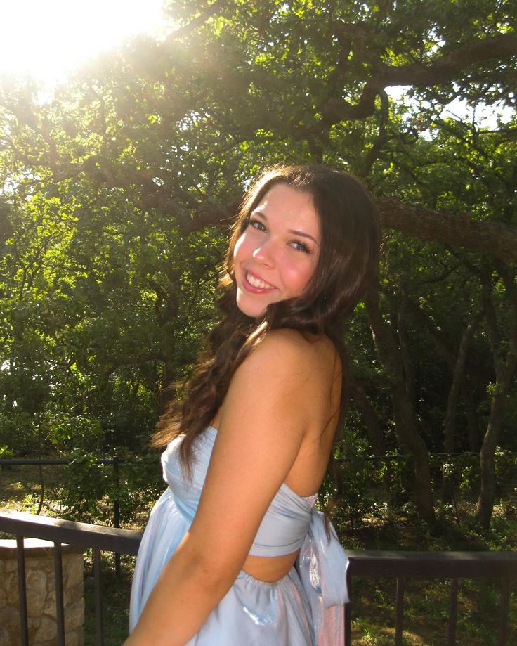 a woman in a blue dress posing for the camera